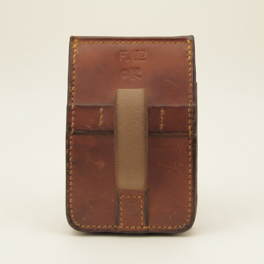 Brown leather case with visible stitching and 'F. LTD' branding.