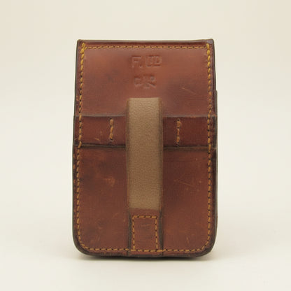 Brown leather case with visible stitching and 'F. LTD' branding.