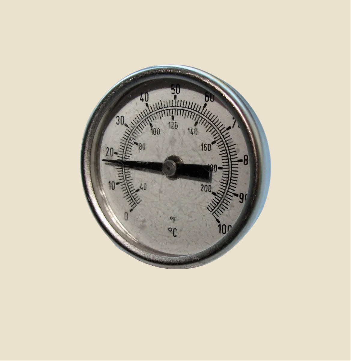 A round analog thermometer with a silver metal bezel, black needle, and dual temperature scales in Fahrenheit and Celsius on a beige background.