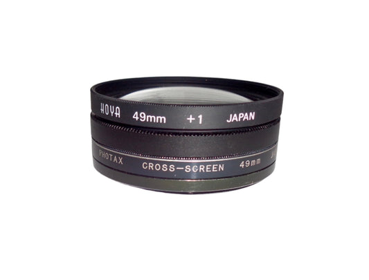 Set of Three 49mm Camera Lens Filters Including A Photax Cross Screen, Hoya +1 And A Close Up Filter