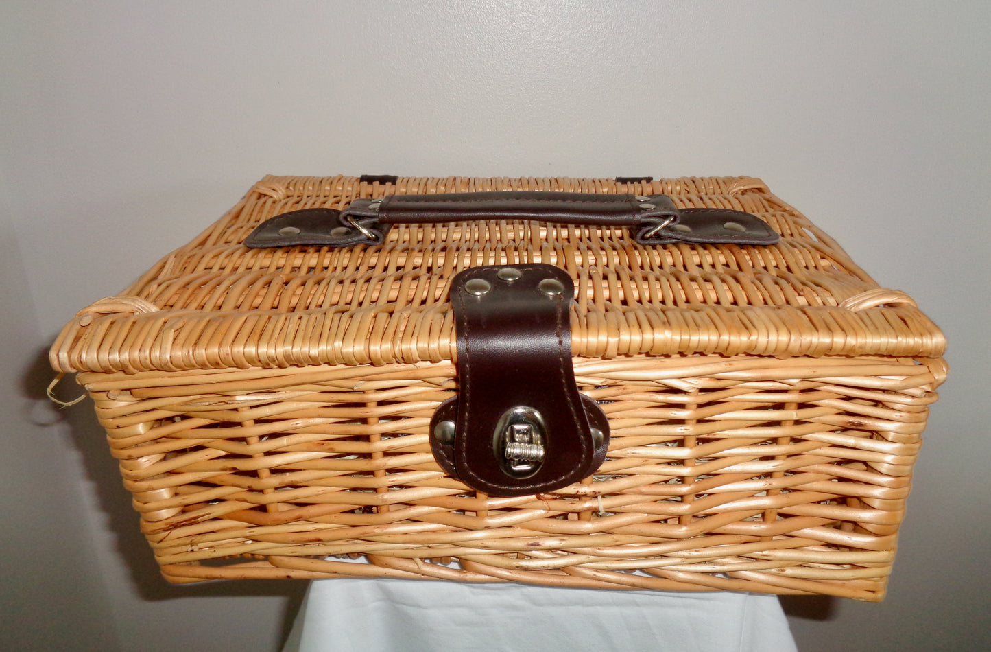 Small Wicker Picnic Basket With Brown Leather Handle and Twist Clasp