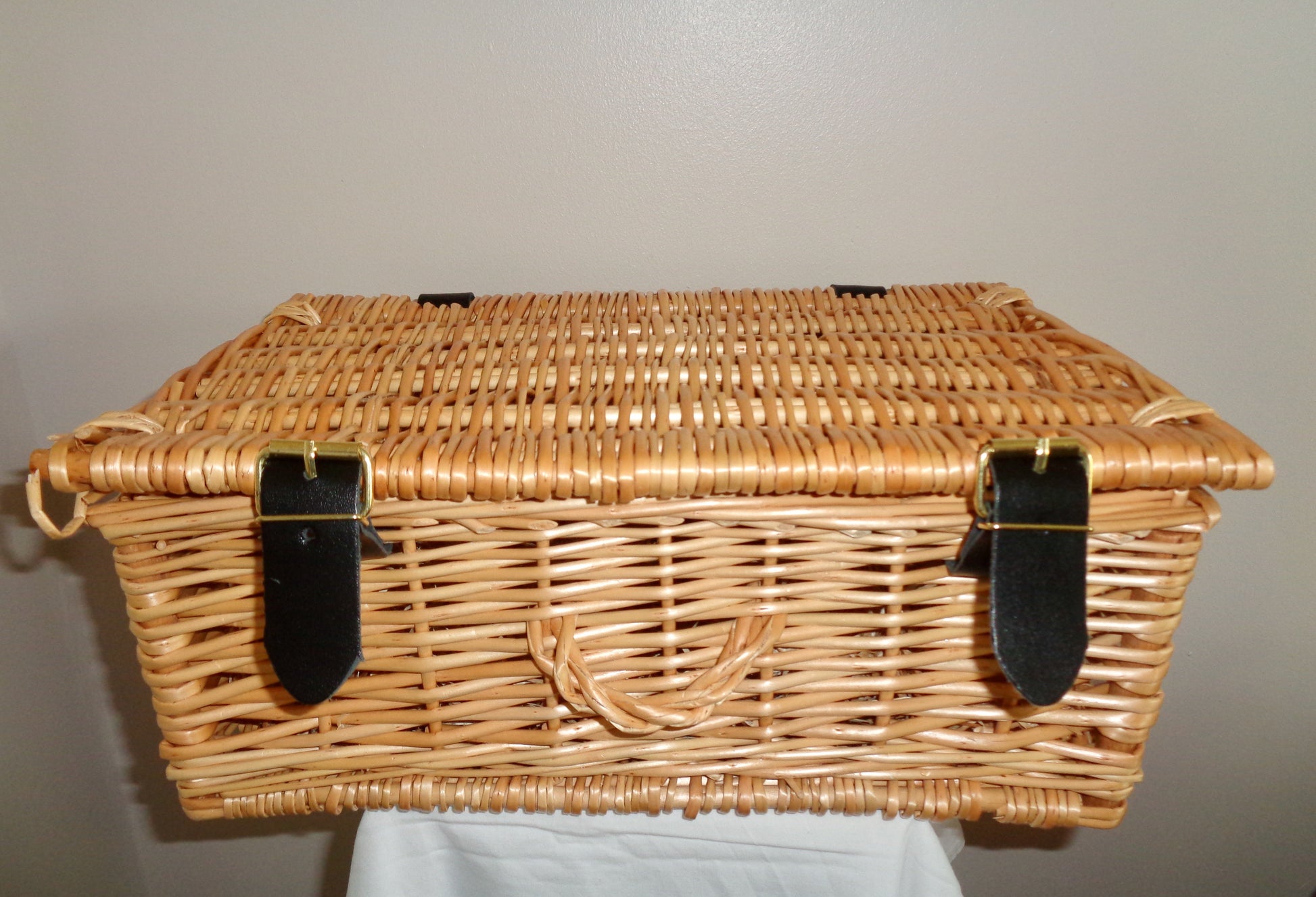 Small Wicker Picnic Basket With Brown Leather Closure Straps And Wicker Handle