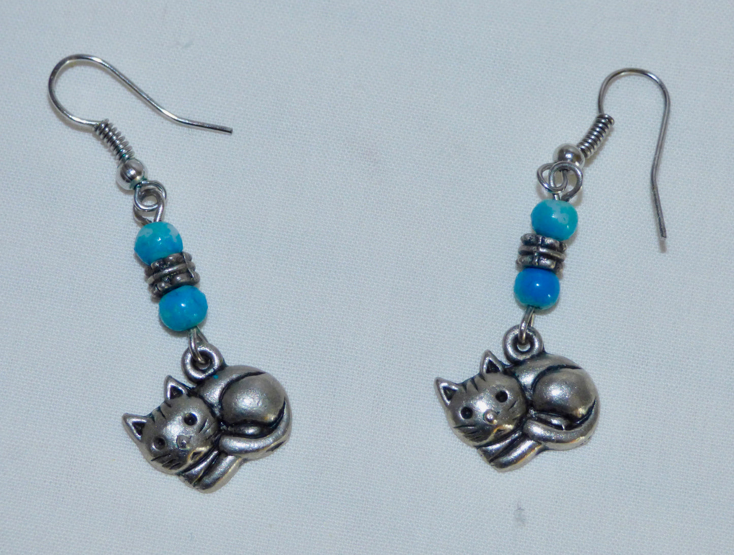 Silver Coloured Metal Cat Dangle And Drop Earrings With Blue Coloured Beads
